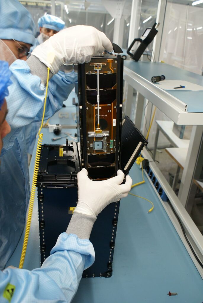 ISISPACE team performing the integration phase of two 6U satellites during the CubeSat Carrier mission.